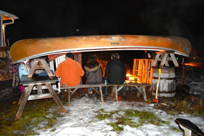 Celebrating the new year by taking shelter under an upturned canoe fireside in Wakefiled. 