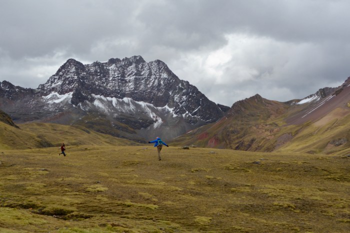 Woman and child running in the Peruvian Andes
