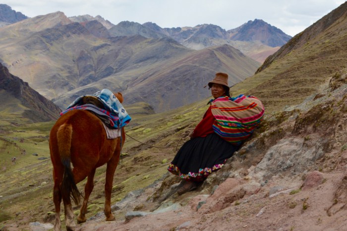 Woman and horse of the Vilcanota Mountain Range, Peru, Rainbow Mountain